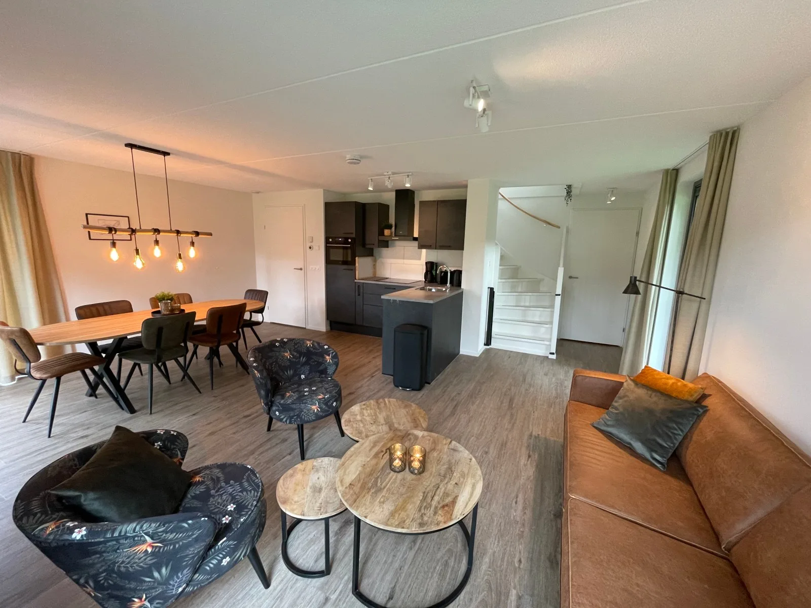 Woonkamer met bank, loungestoelen en salontafels